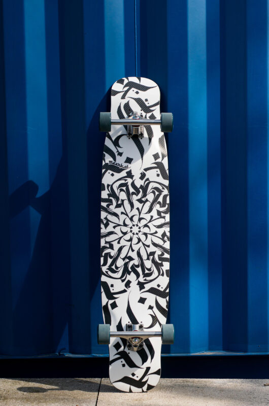 Meerkat Caligraffiti dancing freestyle longboard product photo on a blue container background